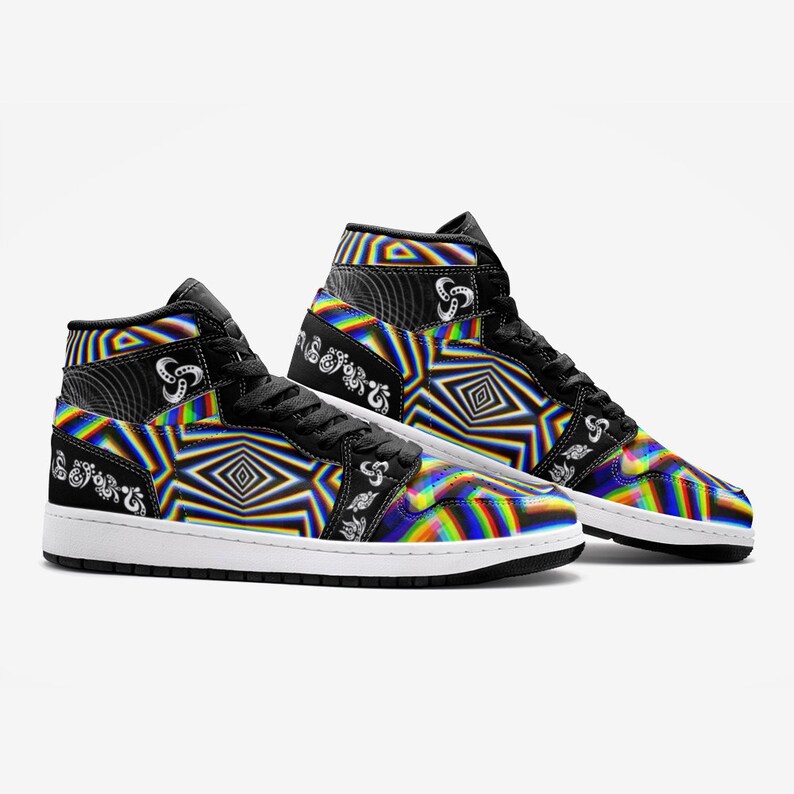 May include: A pair of black high-top trainers with a colourful, psychedelic pattern. The pattern features rainbow stripes, geometric shapes, and a white swirl design. The trainers have a white sole and black laces.