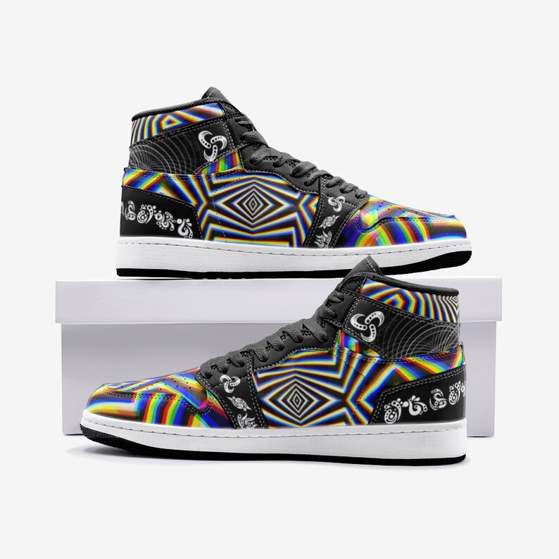 May include: A pair of black high-top trainers with a colourful psychedelic pattern. The trainers have a white sole and a black swoosh logo on the side.