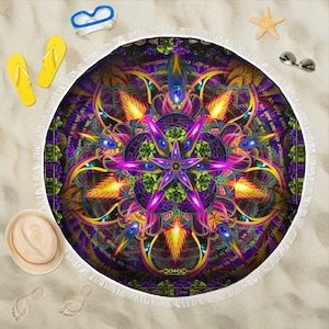 May include: A round beach towel with a colorful mandala design featuring a starburst pattern in shades of purple, yellow, and green. The mandala is surrounded by a border of text in a dark purple color.