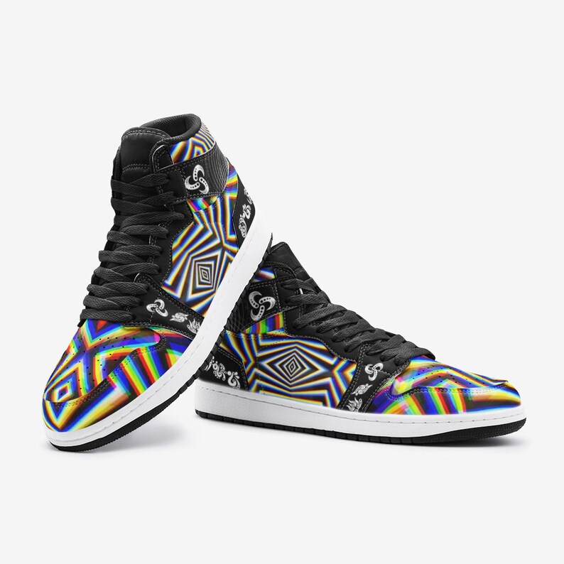 May include: A pair of black high-top trainers with a colourful, geometric pattern. The pattern features a rainbow of colours, including red, orange, yellow, green, blue, indigo, and violet. The trainers have a white sole and black laces.