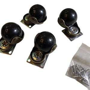 May include: Four black ball casters with antique brass-colored metal frames and mounting plates. A small clear plastic bag containing screws is also included. These casters are suitable for furniture.