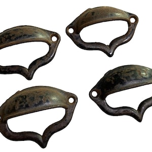May include: Four antique-style metal drawer pulls with a black finish and a heart-shaped cutout. The pulls have a slightly curved shape and are designed to be used on cabinets or drawers.
