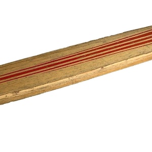 Könnte beinhalten: Ein Skateboard im Vintage-Stil mit einem hellbraunen Holzdeck. Das Deck hat drei parallele rote Streifen, die in Längsrichtung verlaufen. Das Skateboard hat vier Räder mit roten Akzenten, ideal für Freizeitaktivitäten.