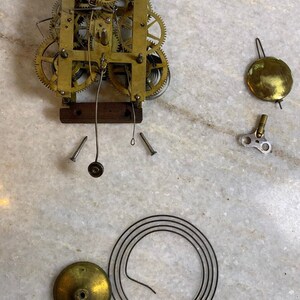 Antique 1875 brass clock parts key gears pendulum bell dong steam punk salvaged