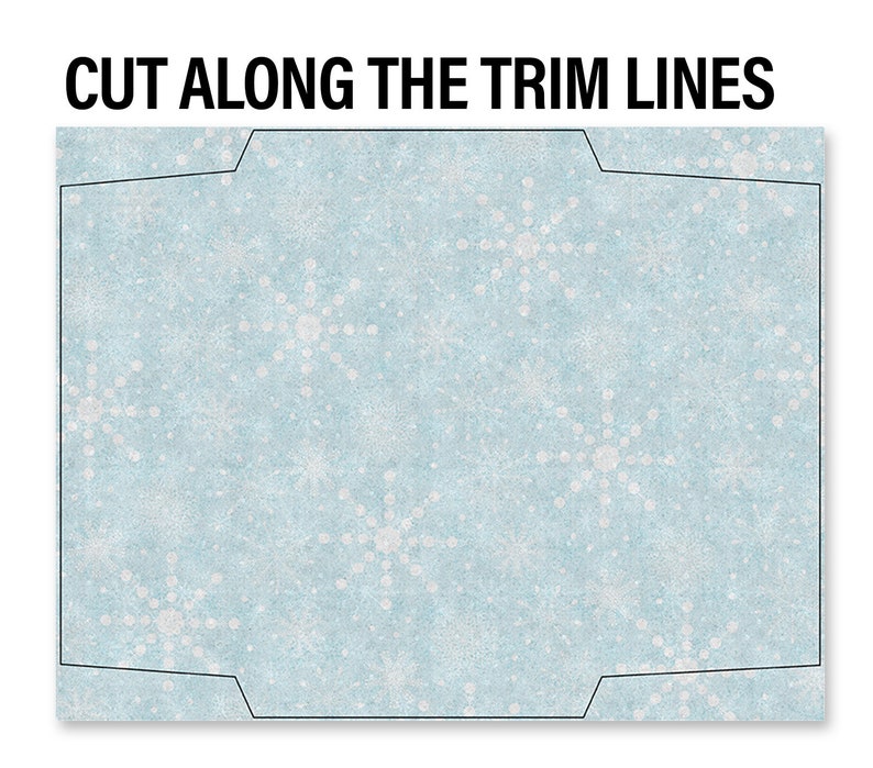 May include: A printable craft template with a light blue background and white snowflake designs. The text "CUT ALONG THE TRIM LINES" is printed at the top of the template.