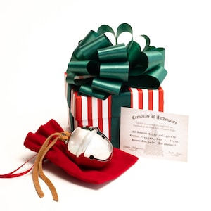 Polar Exp sleigh bell with harness strap, box, bow, and ribbon