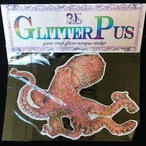 May include: A large pink glitter octopus vinyl sticker with the text "Glitter Pus" and "giant vinyl glitter octopus sticker" on the packaging.