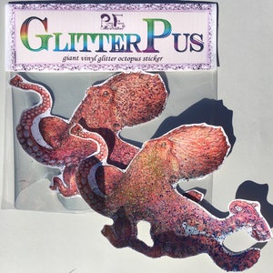 May include: Two large pink glitter octopus stickers on a white background. The stickers are part of a set called "Glitter Pus" giant vinyl glitter octopus sticker.