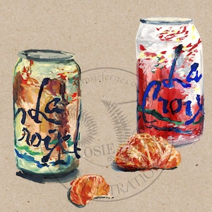 May include: Two cans of La Croix sparkling water, one red and one green, with two orange slices on a brown background.