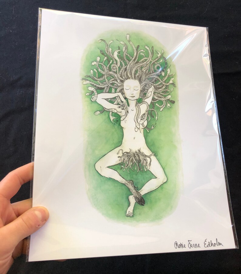 May include: A black and white illustration of a woman with snakes for hair. The woman is lying down on a green background. The illustration is signed "Rosie Jeanne Edholm".