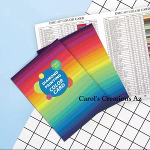 May include: Two color cards for diamond painting. The cards are rainbow colored and feature the text "DMC 447 Diamond Painting Color Card".