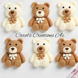 May include: Six small teddy bear figurines, three are brown and three are white. Each bear has a brown bow tie and is sitting with its legs outstretched.