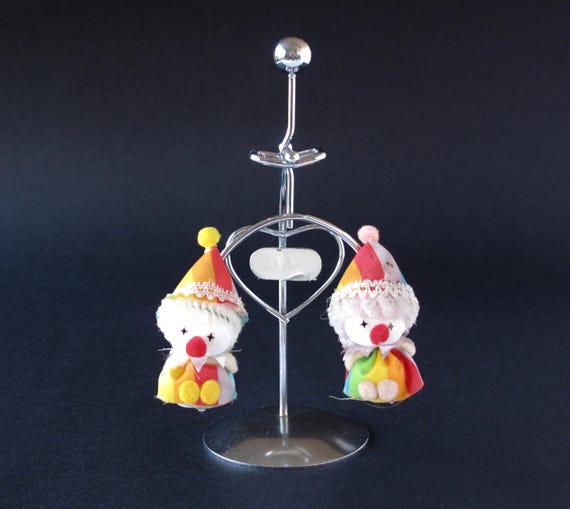 Whimsical balancing clown figures that teeter and right themselves — a charming, character-driven kinetic toy that stands out from the sea of orbital pendulums.