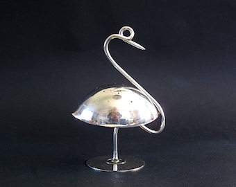 May include: A silver swan-shaped salt and pepper shaker with a domed top and a round base.