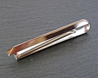 May include: A silver tie clip with a simple design. The clip is made of metal and has a smooth finish.