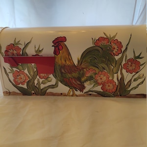 Hand painted standard mailbox. Painted in pretty golden and green rooster amongst some peach flowers. Sealed and uv protected. USA