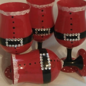 Hand painted sants jeweled suit. Set of 4 wine glasses/goblets. Hand painted.  Great christmas set