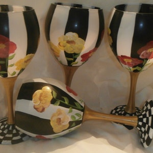 Hand painted red and yellow poppies on stripes. Gold stem and checked base. . Set of 4 wine glasses/goblets. Hand painted.