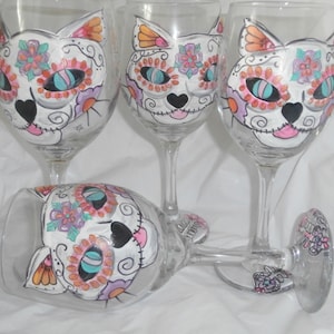 Hand painted sugar skull cats. Set of 4 wine glasses/goblets. Hand painted. Cat sugar skull design with sugar skull fish to top it off.