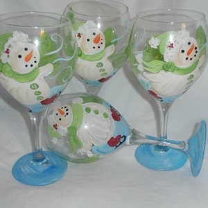 Hand painted skating snoewmen. set of 4  goblets. made in the usa.blue , white red green