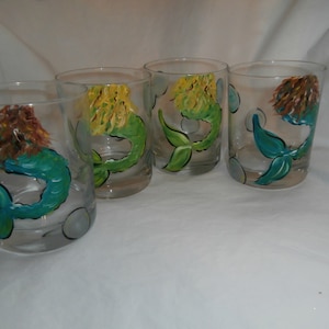 Hand painted mermaids. In teal and green. 2 of each . Set of 4. 15 ounces stemless wines.  . usa. dishwashter top rack safe.