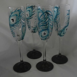 Whimsical blue /teal peacock feather champagne flutes. Set of 4. hand painted. black base.