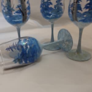 Hand painted winter birch trees and blue pines. Set of 4. 12 ounces  goblets/wines. Snowy stem and base . usa. dishwashter top rack safe.