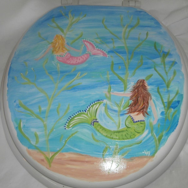 Hand painted swimming mermaids. Standard white toilet seat. Painted on both sides. Sealed. so washable. USA