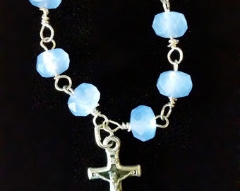 Baby blue glass beads with silver plated crucifix. 3.5" pocket rosary.