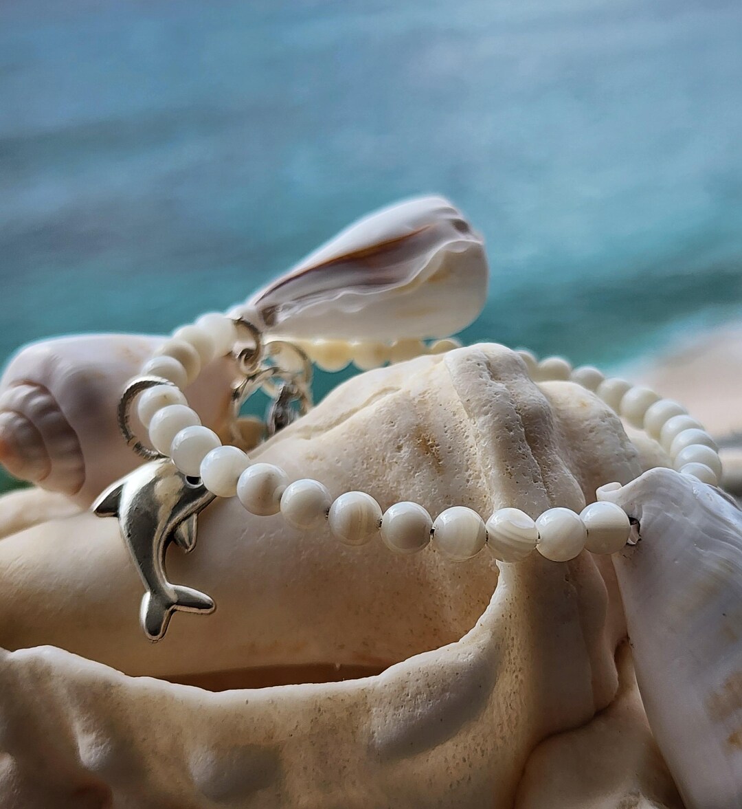 Mother of Pearl With ABC Cone Shells and Dolphin Charm. - Etsy