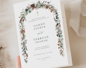May include: A wedding invitation with a watercolor illustration of a floral wreath with a cross at the top. The text reads "The nuptial mass celebrating the union of Candy Andrew and Terruce Graham in the sacrament of holy matrimony Saturday May 18, 20XX S.Paul Cathedral London."