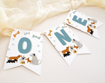May include: A white and blue banner with the word "ONE" in blue letters. The banner is decorated with paw prints and bone designs. There are illustrations of dogs in various breeds and colors.
