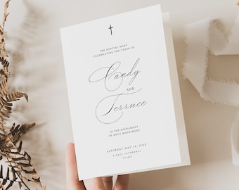 Peut inclure: Une carte d'invitation de mariage blanche avec une croix noire en haut. Le texte indique "La messe nuptiale célébrant l'union de Candy et Terruce dans le sacrement du mariage. Samedi 18 mai 20XX Cathédrale Saint-Paul, Londres."