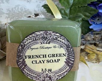 May include: A green bar of soap with a brown label that reads "Organic Boutique & Spa French Green Clay Soap 2.5 oz".