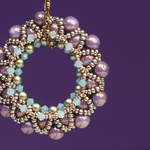 May include: A circular beaded earring with a gold wire loop, featuring a mix of iridescent purple, gold, and light blue beads.