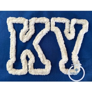 May include: White fluffy letters "KY" in a bold, blocky font style, outlined in white, on a royal blue background.