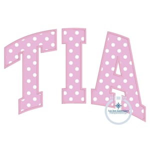 May include: Pink polka dot letters spelling the name "TIA" in a bold, blocky font style.