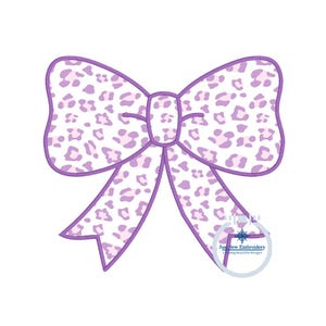May include: A purple bow with a white and pink leopard print design. The bow is a digital embroidery design.