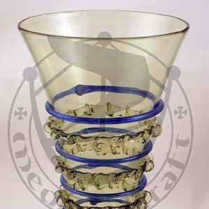 May include: A green glass goblet with a wide, flared mouth and a ruffled base. The goblet has four blue bands around the middle.