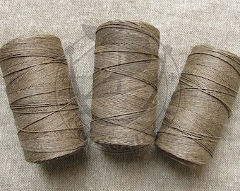 May include: Three spools of brown thread, each wound with a different pattern.