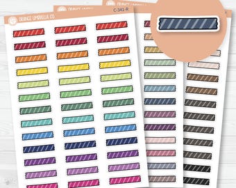 May include: Sheets of colorful planner stickers featuring rectangular designs with diagonal stripes. The stickers come in a variety of colors, including red, orange, yellow, green, blue, purple, and brown. The stickers are from Orange Umbrella Co.