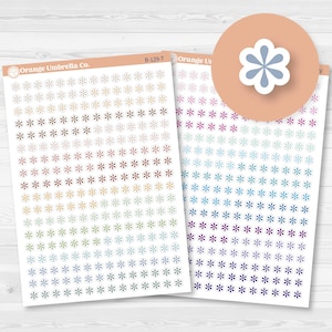 May include: Sheets of flower-shaped stickers in various colors, including brown, gold, green, blue, purple, and pink. The stickers are arranged in a grid pattern. The brand name "Orange Umbrella Co." is visible.