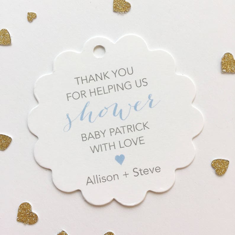 May include: White scalloped thank you tag with blue text that reads 'Thank you for helping us shower Baby Patrick with love Allison + Steve' with a blue heart symbol. Not sure what to write? See the next photo ⬇️