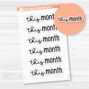 May include: A sheet of planner stickers featuring the words "this month" in a handwritten style. The stickers are black with a white border, and a matching sticker is on a peach-coloured circle. The Orange Umbrella Co. logo is in the upper left corner.