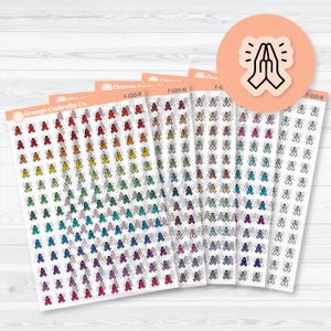 May include: Sheets of stickers from Orange Umbrella Co. featuring a praying hands design in various colors. The stickers are arranged in rows and columns, with a peach-colored circle sticker with praying hands in the upper right corner.