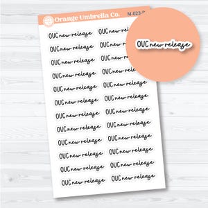 May include: A sheet of stickers with the text "OUC new release" in a handwritten font. The stickers are white with black text and are arranged in rows. The Orange Umbrella Co. logo is in the upper left corner.