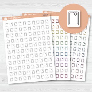 May include: Sheets of planner stickers featuring a tablet design with a heart icon. The stickers are in various colors, including gray, green, blue, purple, and red. The brand name "Orange Umbrella Co." is visible on the sheets.