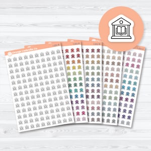 May include: Sheets of colorful library-themed planner stickers. Each sheet has a different color scheme, including red, orange, green, blue, and purple. The stickers are small and feature a simple library building design.