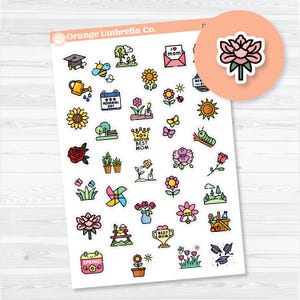May include: A sheet of colourful stickers featuring spring and garden-themed illustrations. Designs include flowers, butterflies, a watering can, a bee, and the text "Best Mom" and "Spring". The stickers are on a white background.