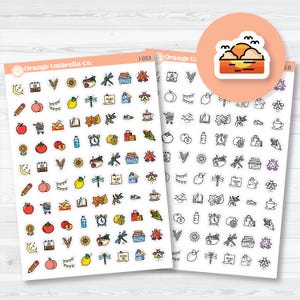 May include: Two sheets of colorful planner stickers with various illustrations, including fruits, flowers, and icons. The stickers feature text like "Orange Umbrella Co." and "AUG". A circular sticker with a sunset design is also visible.